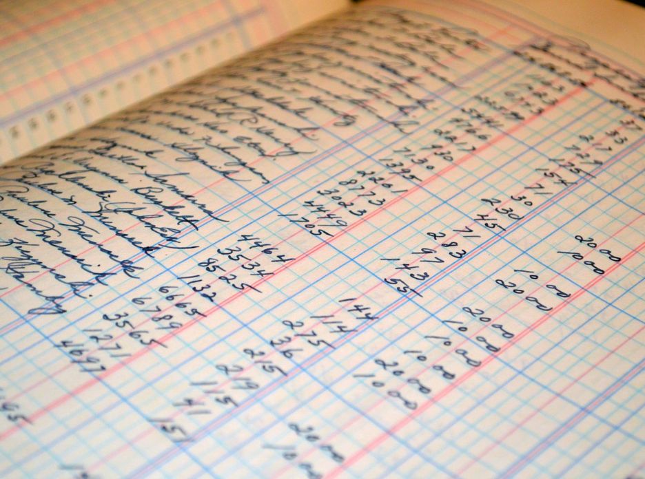 Close-up of a vintage handwritten ledger detailing financial records and accounts