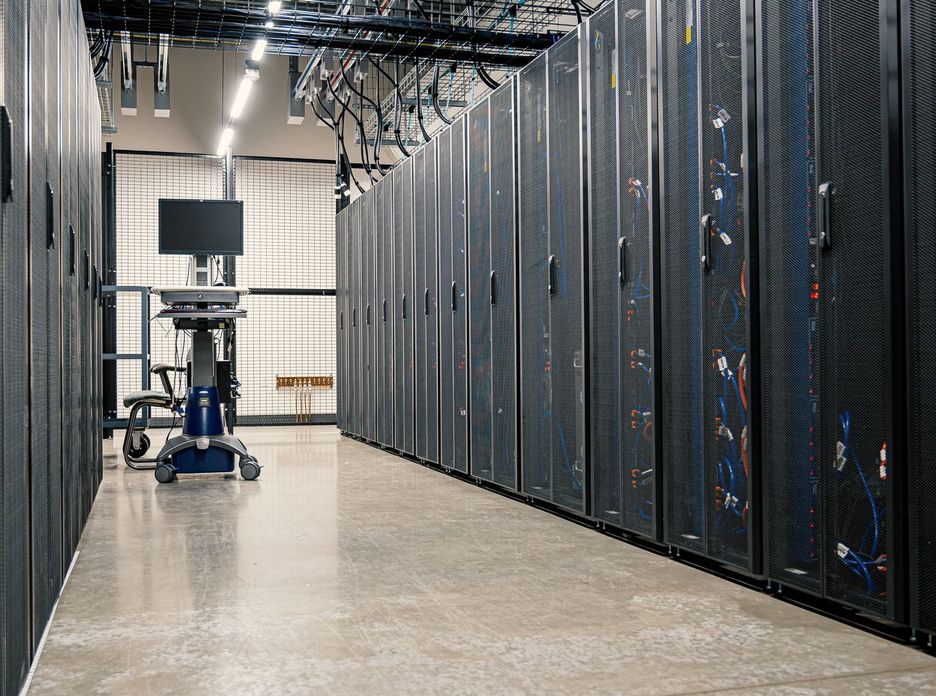 Steel framework cabinets housing servers networking devices and cables in contemporary equipped data center