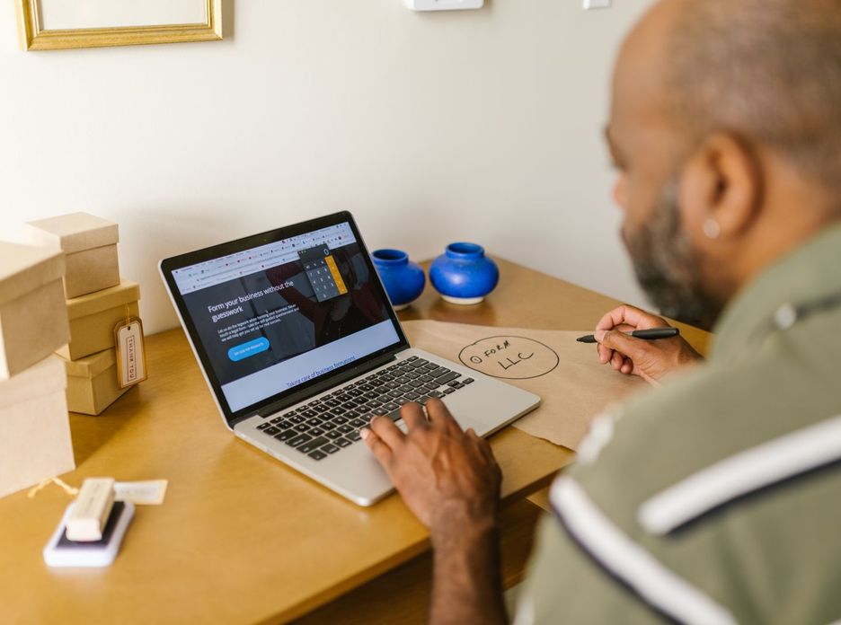 Entrepreneur at a desk using a laptop for business planning